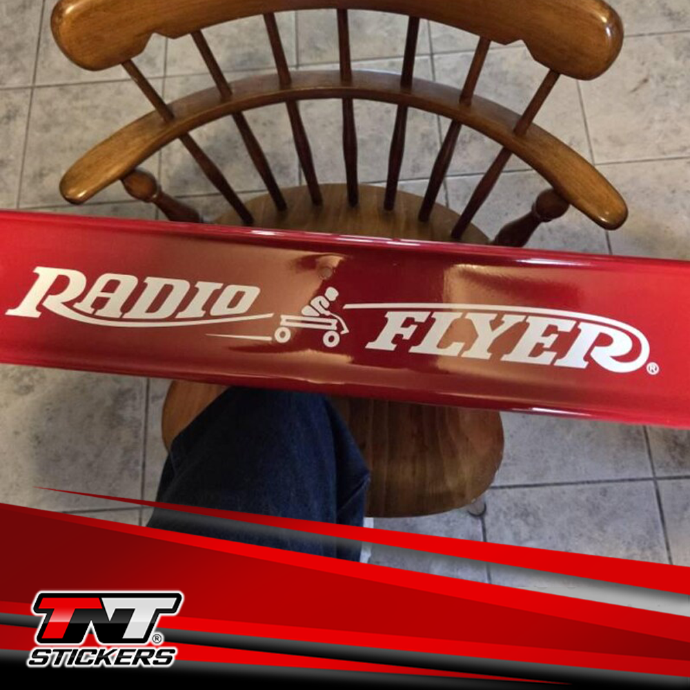 Red Radio Flyer wagon with restoration sticker with TNT Stickers logo at the bottom.